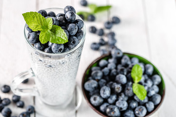 Chia pudding with berries and milk, sweet nourishing dessert, healthy breakfast superfood concept