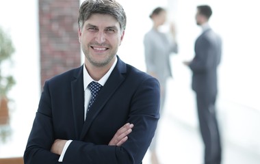 Fototapeta premium Portrait of confident businessman on office background