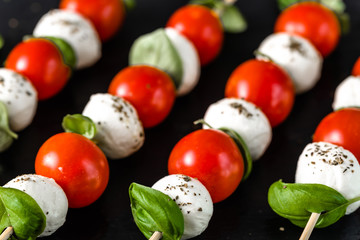 Italian food - caprese salad - skewer with tomato, mozzarella and basil, mediterranean diet concept