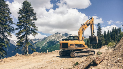 Digger working on a mountain road. Caucasus mountains, Svaneti region, Georgia © margentum