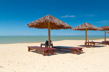 Tropical beach scenery with parasol in Thailand