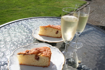 A piece of fruit cake with Swedish apples Transparent Blanche together with a glass of white wine