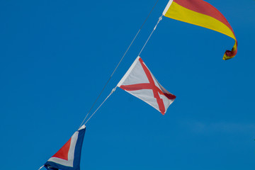 Navigational signal flags flying in the mast