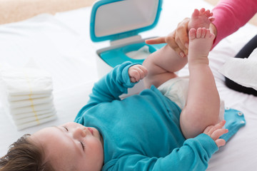 Little baby boy being cared for by his mother