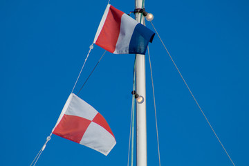 Navigational signal flags flying in the mast