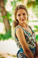Young beautiful girl in floral dress