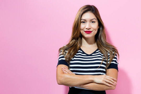 Happy young woman on a pink background