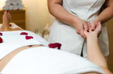 Obraz na płótnie Canvas Physiotherapist massaging female palm