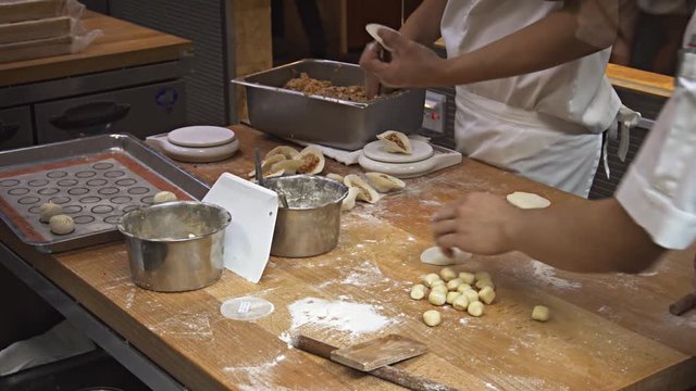 Cooks at Work in a Singapore Restaurant. Video 4k UltraHD