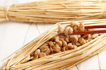 Natto fermented soy beans wrapped in rice straw on white background - 169416853