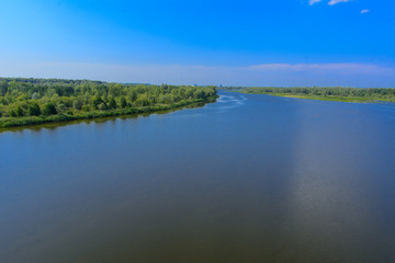 A beautiful river landscape and trees in a dead radioactive zone. Consequences of the Chernobyl nuclear disaster, August 2017.