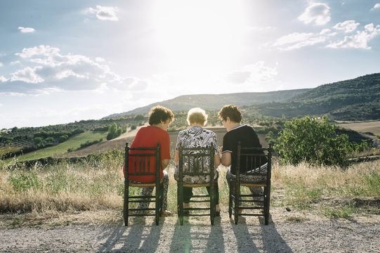 Three women of age advanced with smartphone, in the field - Powered by Adobe