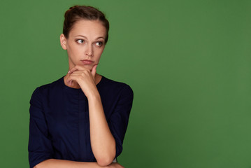 Pretty brunette woman looking away having doubtful