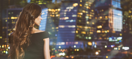 woman looking at night city