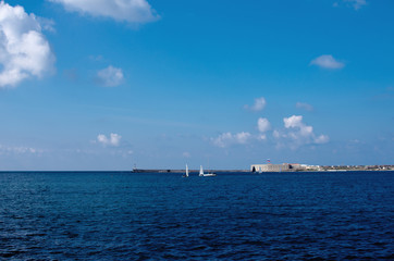 Entrance to the sea bay of Sevastopol with small yachts and ravelins in the background.