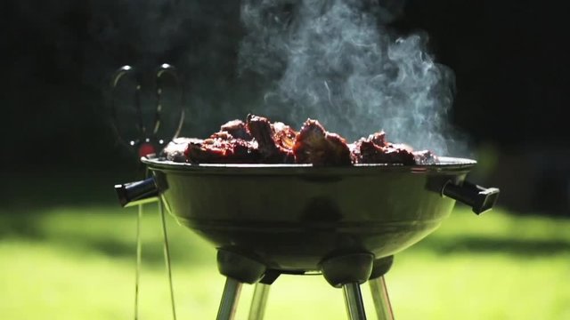 barbecue meat on grill or brazier outdoors