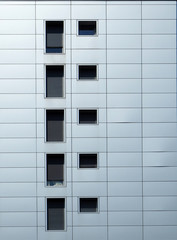 Facade detail of aluminum composite panel with windows of two different form
