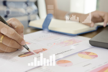 Young finance market analyst working at office at white table.Businessman analyze document and the calculator in hands.Graphs and diagram