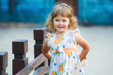 Cute little girl having fun outdoors in the summer park