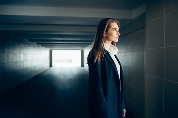 Beautiful lonely woman in a subway tunnel