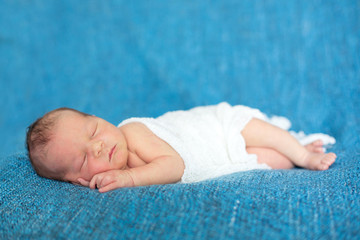 Newborn baby boy, sleeping happily