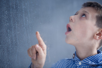 Boy watches rain