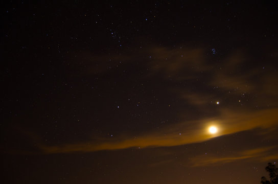 Clouds obscure the moon on a starry  night near Heflin, Alabama, USA