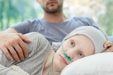 Woman with nasal cannula lying