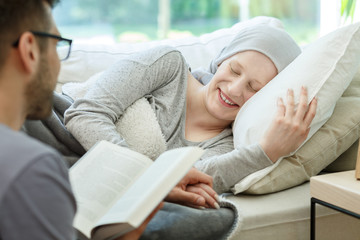 Reading book to cancer survivor