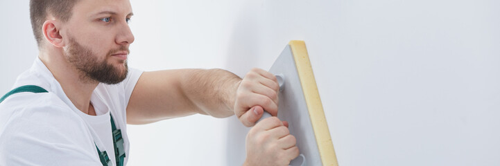 Professional builder plastering wall