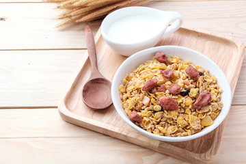 cornflakes and dry fruits on wooden background