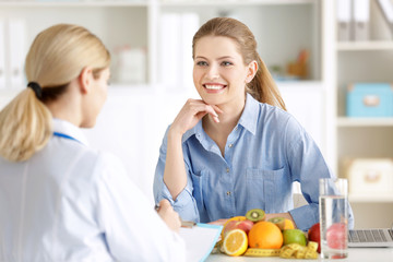 Young woman at nutritionist's office. Weight loss concept
