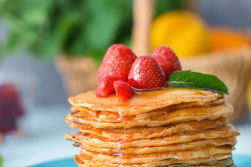 Delicious pancakes with honey and strawberry, close up