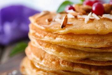 Delicious pancakes with nuts and berries, close up