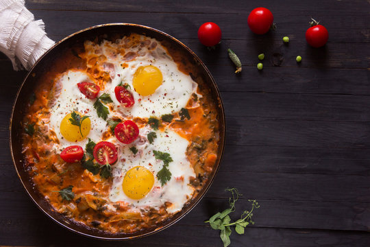 three fried eggs with сherry tomatoes