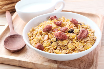 cornflakes and dry fruits on wooden background