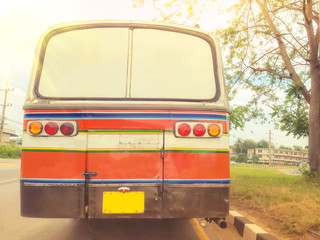 backside of orange vintage bus from countryside of thailand