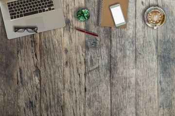Wooden office desk table with a lot of things on it. Top view with copy space.