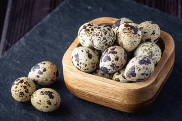 Obraz premium Eco farm quail eggs on dark wooden background. Concept of home made natural food