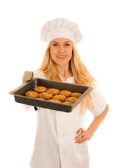 beautiful blond woman in chef dress bakes cookies isolated over white background