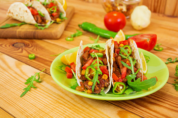 Mexican tacos with beef in tomato sauce