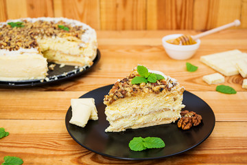 Honey cake with cottage cheese, oranges and nuts, decorated with white chocolate