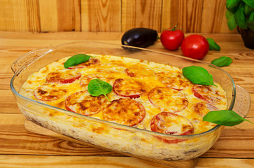 Eggplant casserole. Moussaka on wooden background