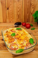 Eggplant casserole. Moussaka on wooden background