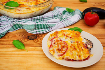 Eggplant casserole. Moussaka on wooden background