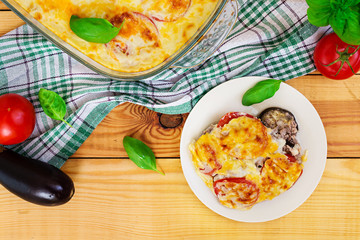 Eggplant casserole. Moussaka on wooden background