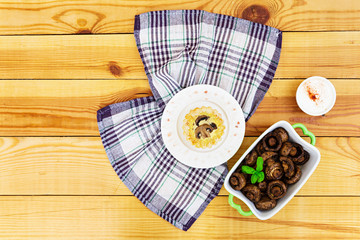 Tartlets with champignons on wooden background