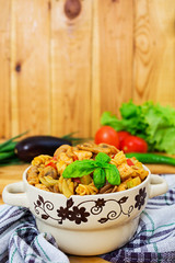 Pasta with vegetable sauce on wooden background
