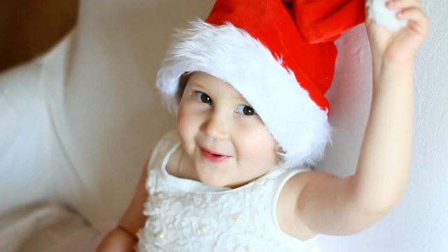 Funny child in Santa Claus hat close-up. The concept of Christmas and New Year.