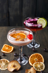 Colorful cocktails over rustic wood background
